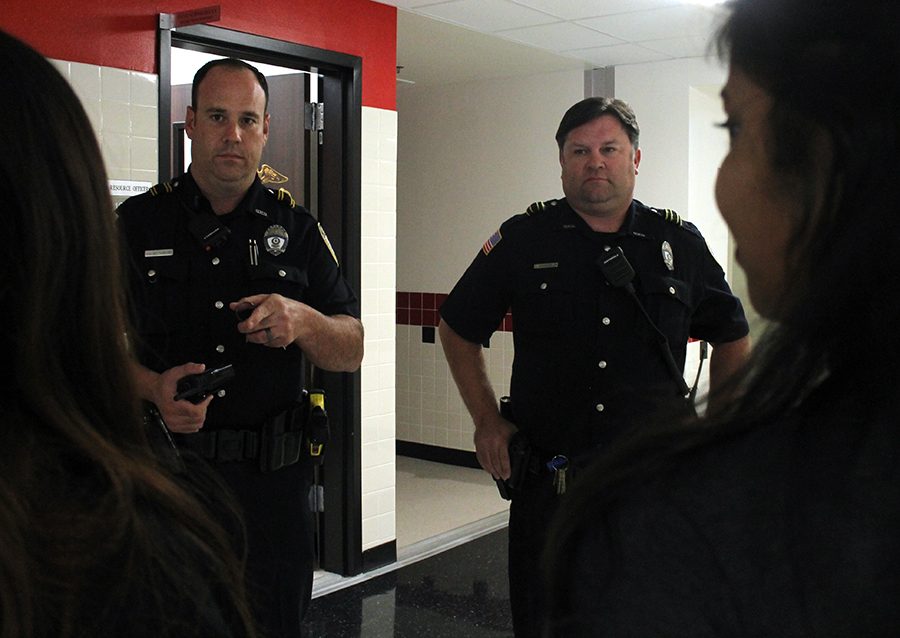 Officers Chris Mittendorf and Steve Schnoeblen speak to students during lunch. Both officers are new to North and have been making an effort to get to know their new Raider family.